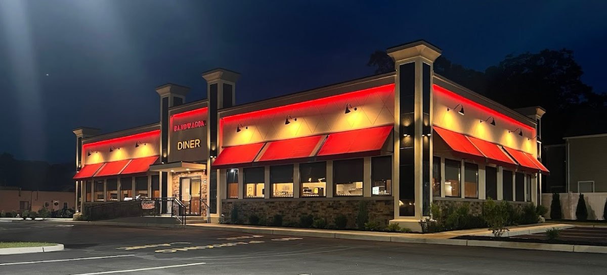 Bandwagon Diner on Route 37 at night, red awnings lit under the roofline